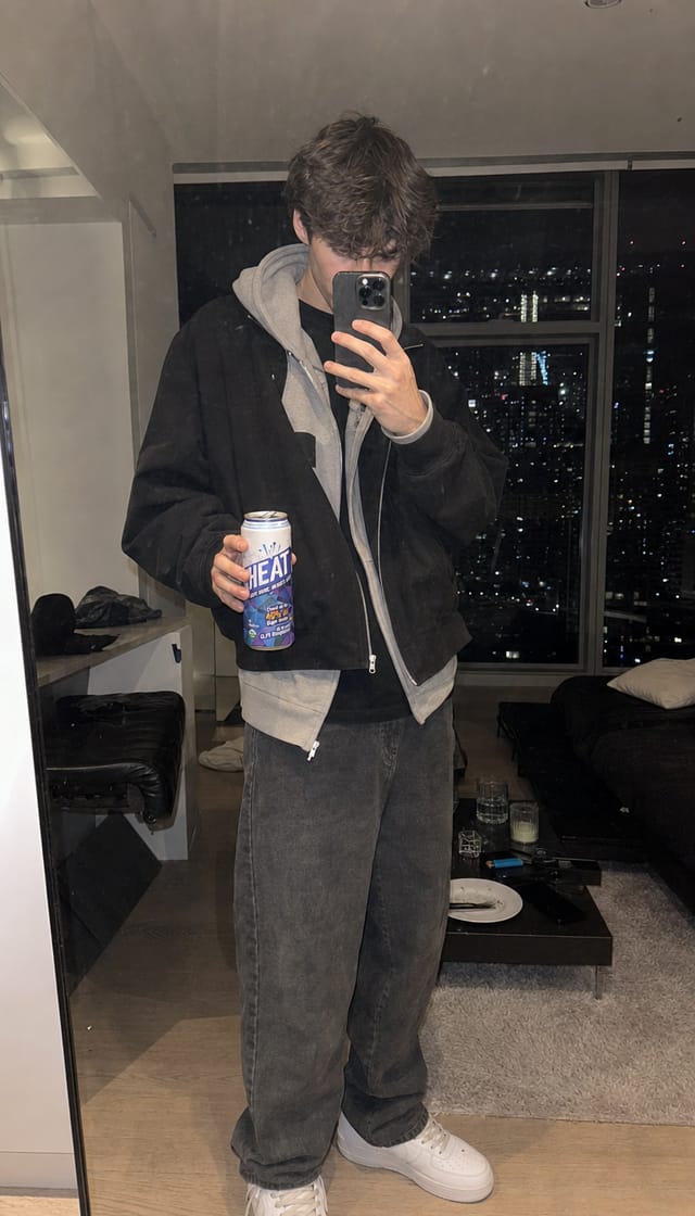 Streetwear fit check in a mirror, sneakers, layered hoodie, city apartment