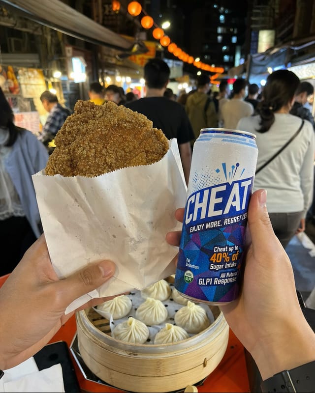 Taipei night market, a paper bag of fried chicken cutlet and a stack of xiao long bao, crowd, lanterns